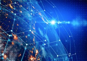 Abstract image of the earth with suggestion of data/connectivity surrounding the earth from space.